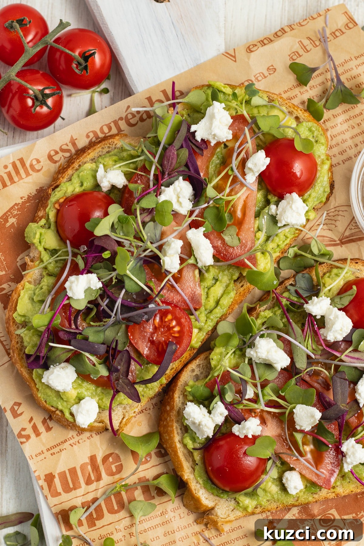Tomato Goat Cheese Avocado Toast 2 Avocado toasts with tomato, goat cheese and microgreens.