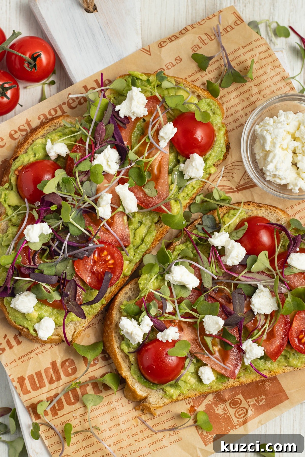 Tomato Goat Cheese Avocado Toast 9 Two avocado toasts with tomato, goat cheese and microgreens.