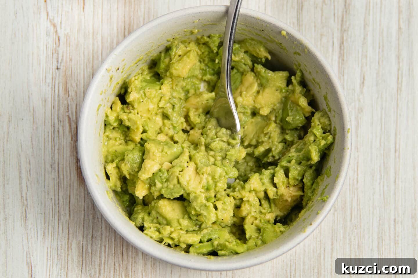 Tomato Goat Cheese Avocado Toast 5 A bowl with mashed avocado.