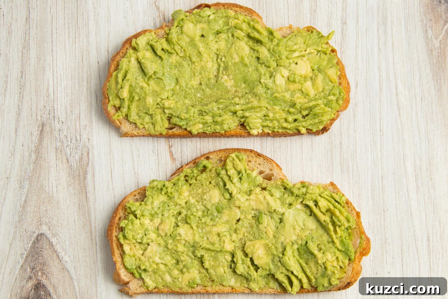Tomato Goat Cheese Avocado Toast 6 Two slices of toast topped with mashed avocado.