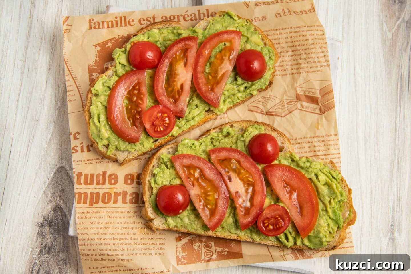 Tomato Goat Cheese Avocado Toast 7 Two avocado toasts topped with sliced tomatoes.