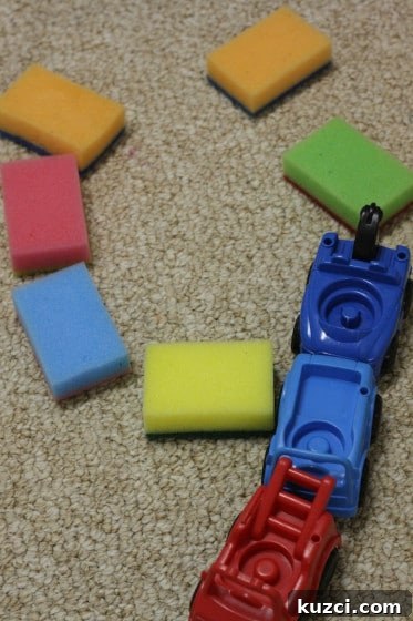playing with coloured sponges and toy cars