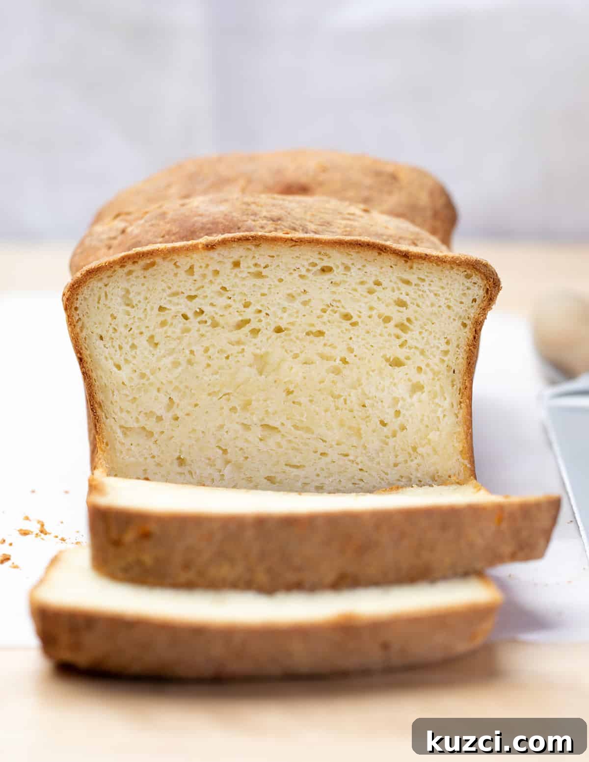 Closeup image of loaf of bread with 2 slices cut
