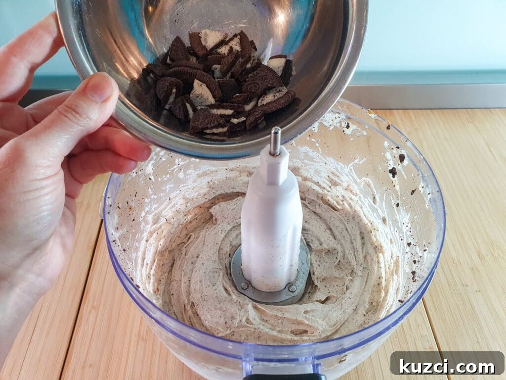 Cookies and Cream Nice Cream Recipe 11 Adding second batch Oreos to blended bananas.