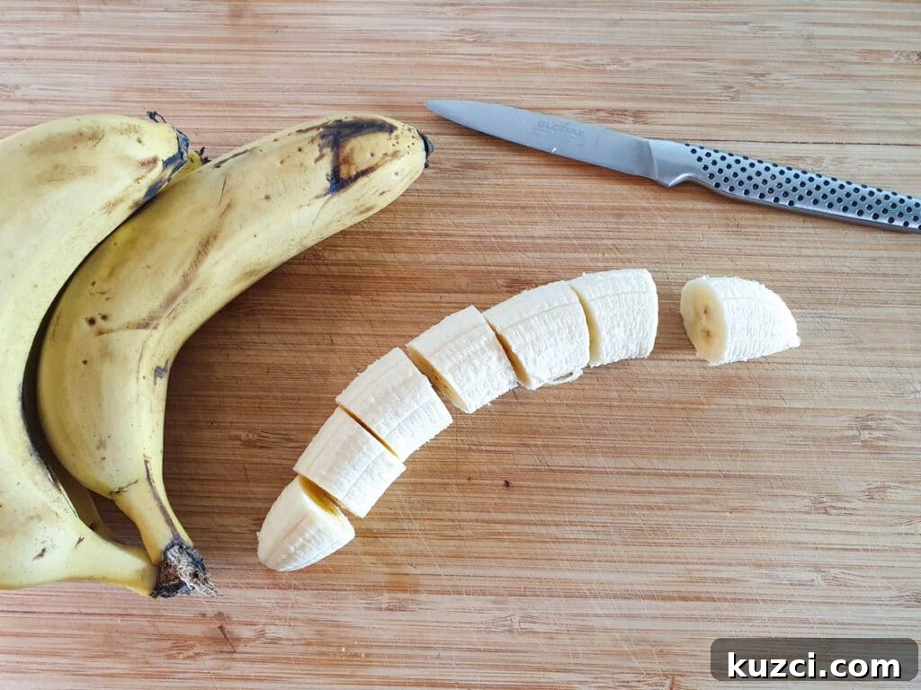 Cookies and Cream Nice Cream Recipe 4 Peeling and slicing bananas into coins.