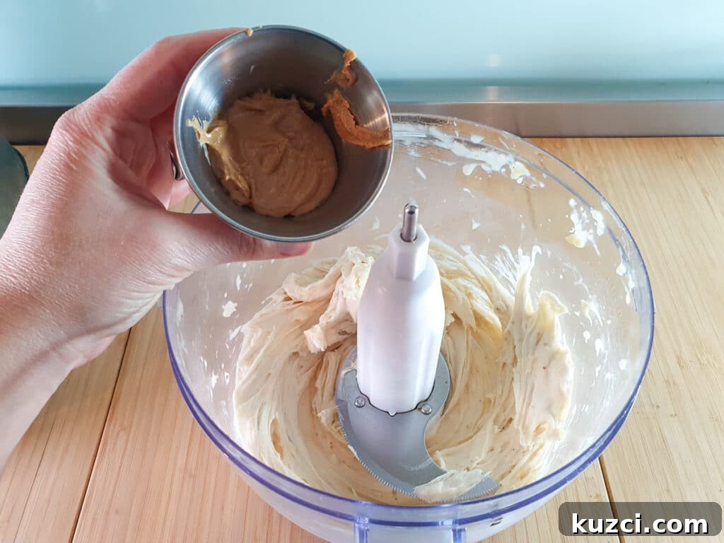 Cookies and Cream Nice Cream Recipe 9 Adding cashew butter to blended bananas.