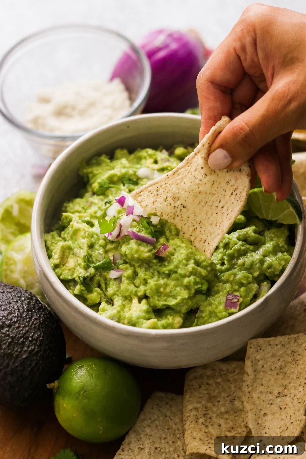 Homemade Keto Guacamole Recipe for Low Carb Avocado Dip 4 dipping a chip into guacamole