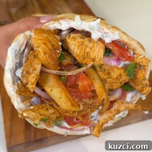 Chicken gyro with pita, chicken, vegetables, and tzatziki sauce