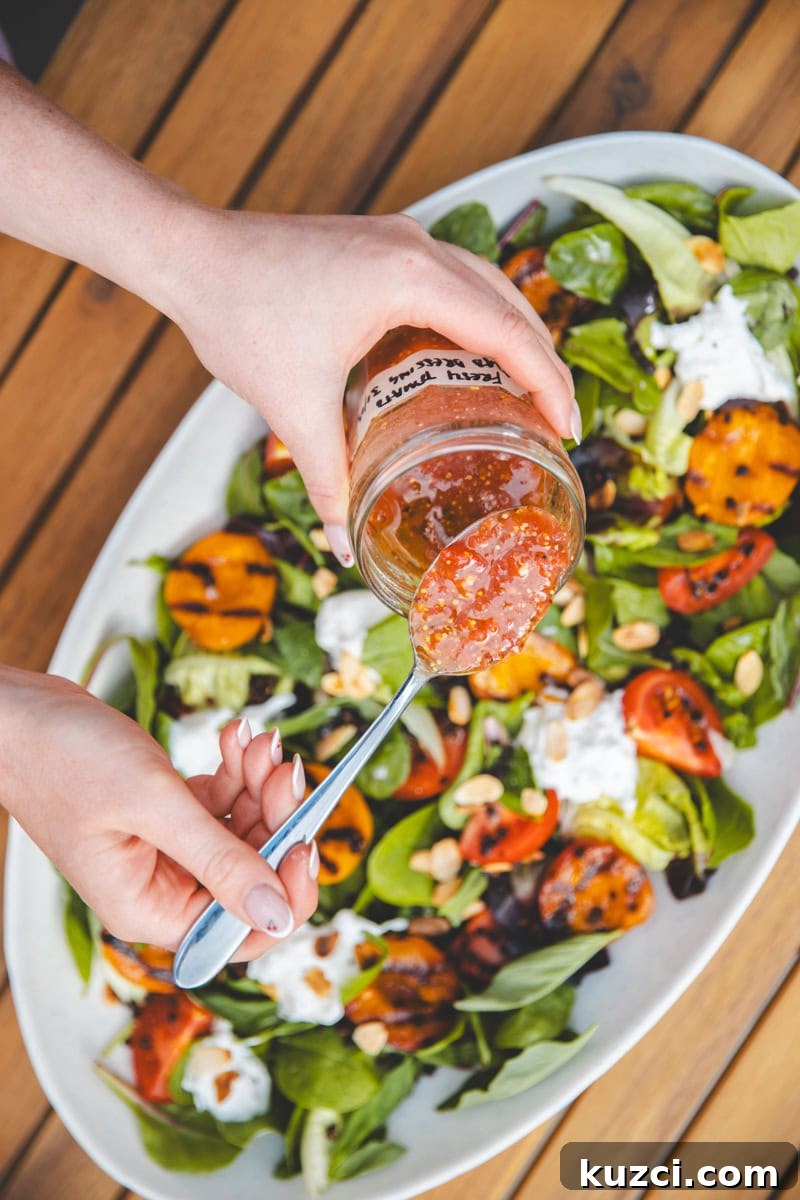 Grilled Apricot Salad with Arugula and Feta 3 Pouring dressing on Griddled Apricot Salad - Georgie Eats