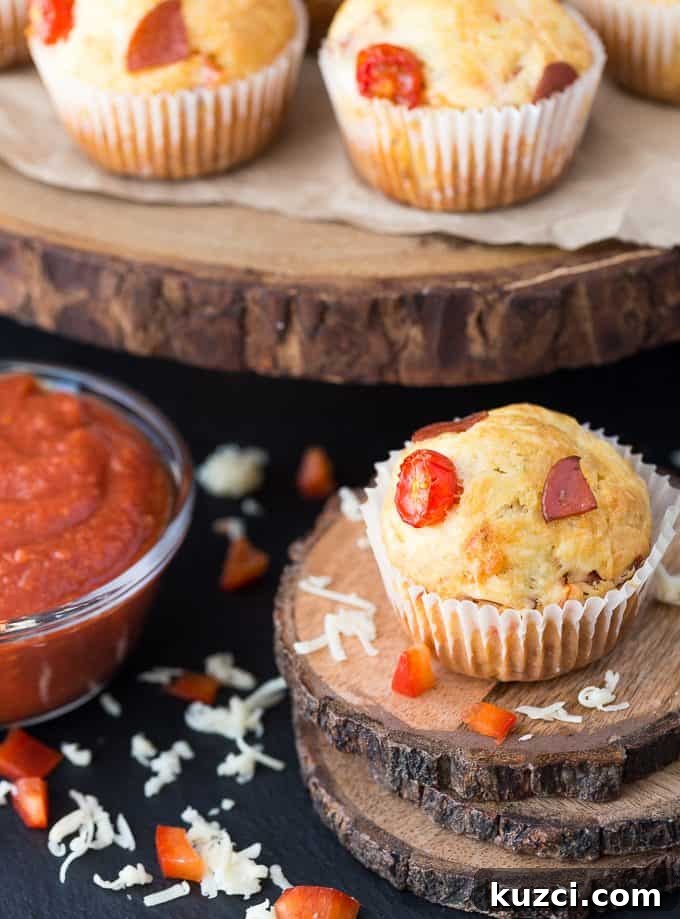 Mini Pizza Muffins with Mozzarella and Pepperoni 2 Pizza Muffins - This kid friendly snack tastes and smells like pizza, but in a muffin form. Add in your fave toppings to change it up!