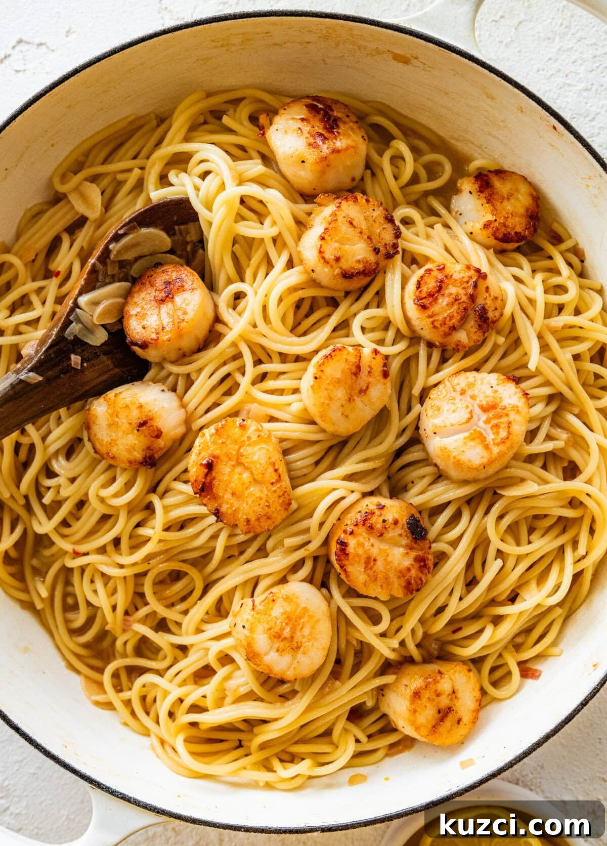 Scallop Pasta with Lemon Garlic Sauce 12 Spoon stirring together the pasta and scallops.