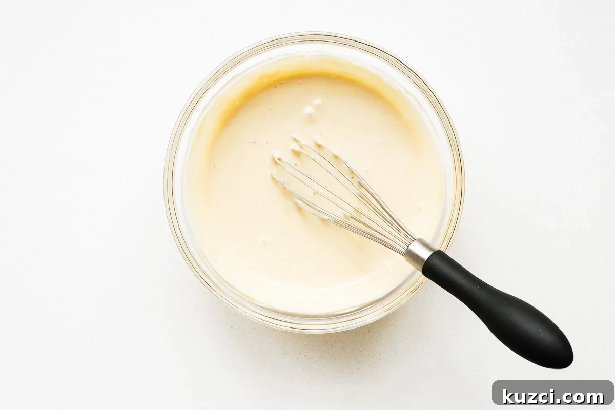 The plant-based maple tahini dressing is whisked until ultra-creamy, light and airy.