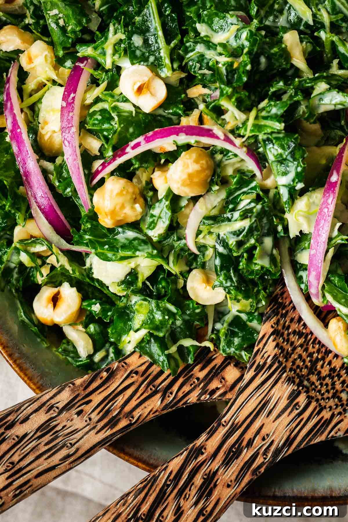 A close-up of the vegan tahini kale salad with toasted hazelnuts.