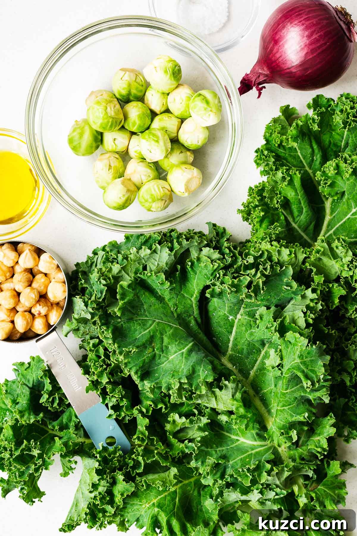 Kale salad ingredients arranged on a kitchen counter.