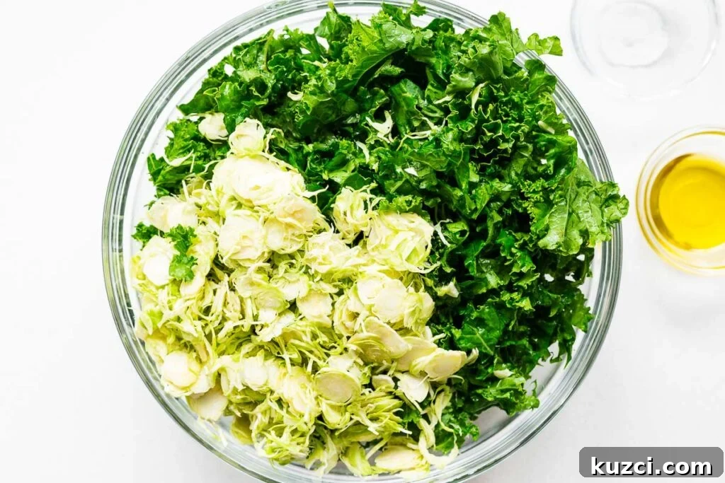 A bowl of chopped kale leaves and shredded Brussels sprouts.