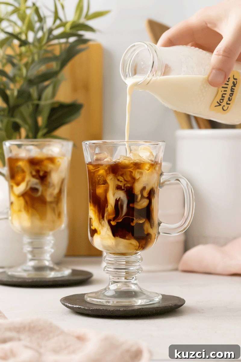 Homemade Vanilla Coffee Creamer Recipe 5 Homemade coffee creamer being poured into iced coffee.