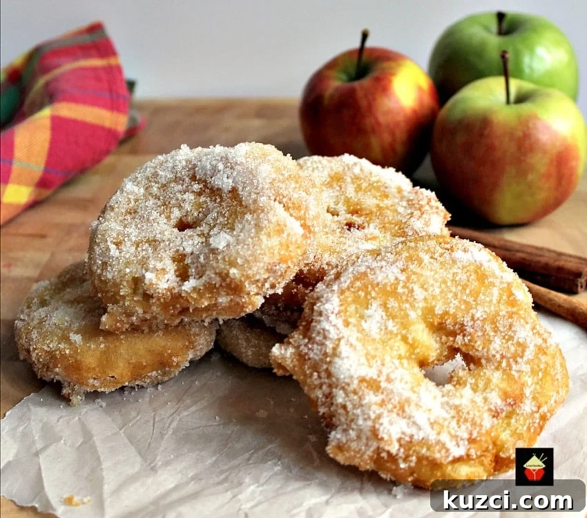 Apple fritters served warm with syrup and ice cream
