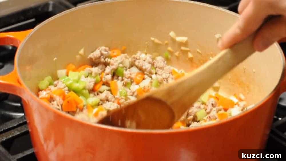 Classic Italian Pasta e Fagioli Soup Recipe 5 Softening vegetables with sausage