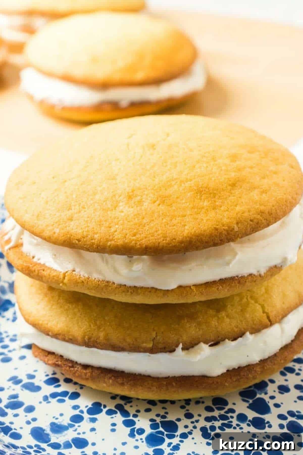 2 vanilla Whoopie Pies with cream filling on plate