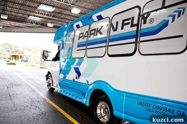 A blue and white Park 'N Fly shuttle bus in a parking garage