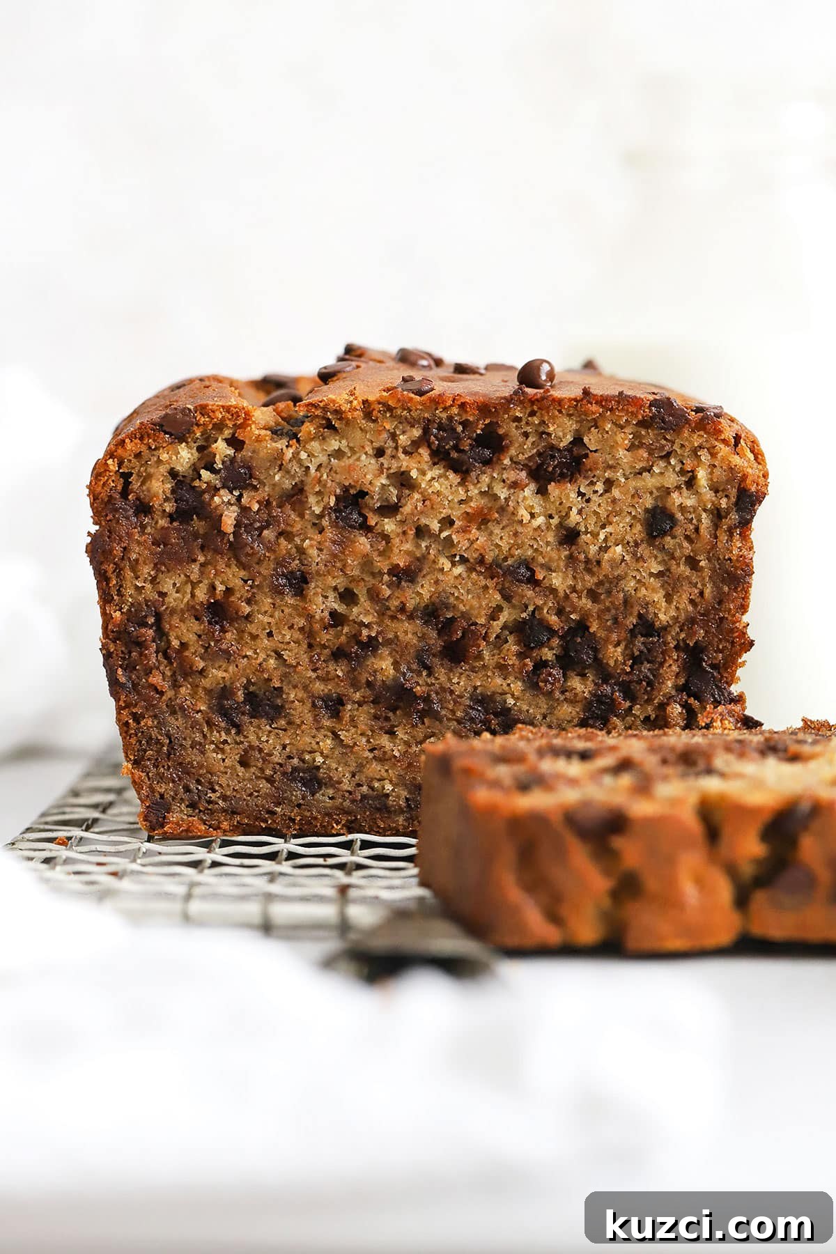 slicing a loaf of gluten-free chocolate chip banana bread
