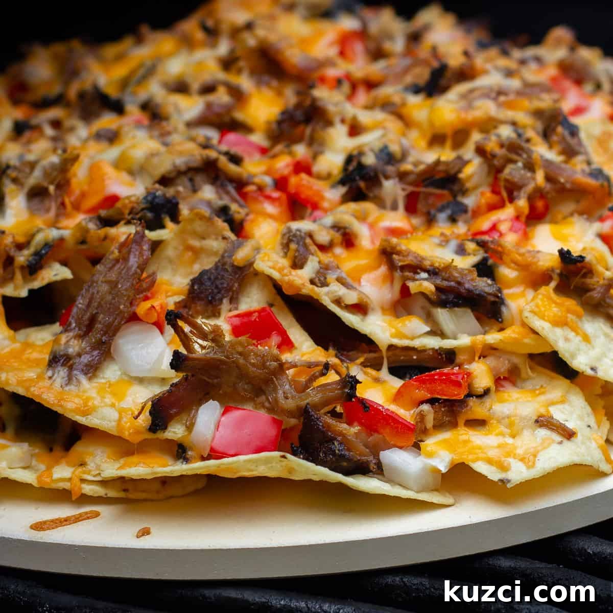 Pulled Pork Nachos with Melted Cheese and Jalapeños 4 Nachos baked on a round pizza stone