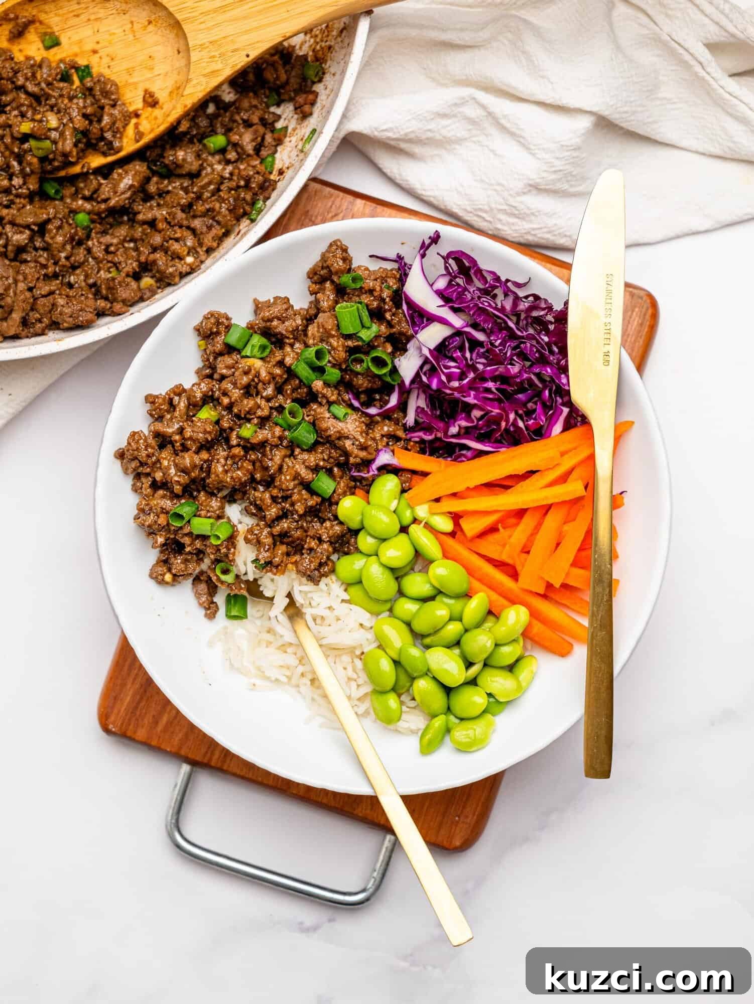 High Protein Teriyaki Beef Bowls for Meal Prep 12 Teriyaki Beef Bowls with rice and crunchy veggies in a white bowl.