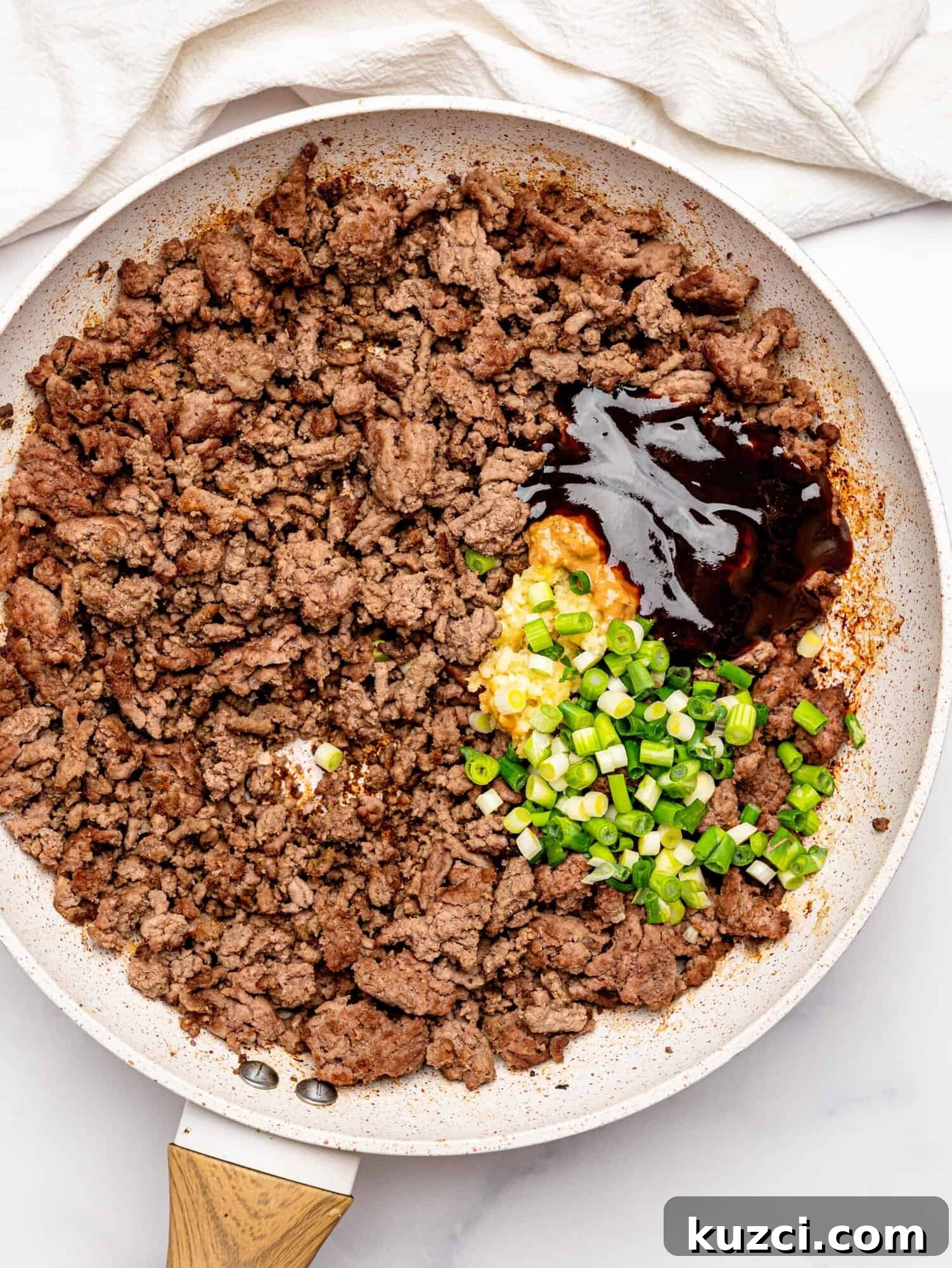 High Protein Teriyaki Beef Bowls for Meal Prep 10 Cooked beef mince, garlic, ginger, and teriyaki sauce in a frying pan.