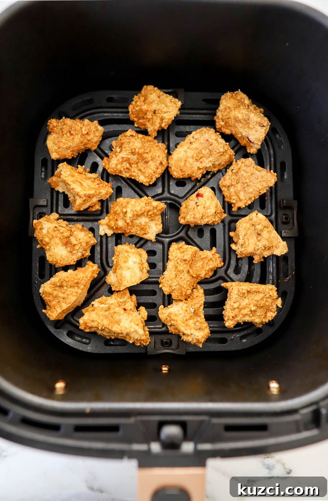 Crispy Air Fryer Tofu Nuggets Vegan and Gluten Free 6 tofu cubes in air fryer basket in a single layer