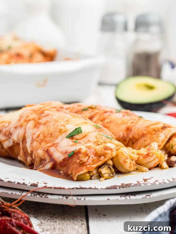 Crawfish-Stuffed Baked Potatoes Recipe 9 close up of a plate of crawfish enchiladas with some avocado in the background